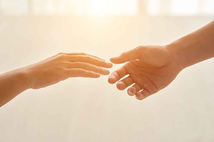 Deux mains tendues pour aider une personne atteint d'un sentiment d'impuissance.